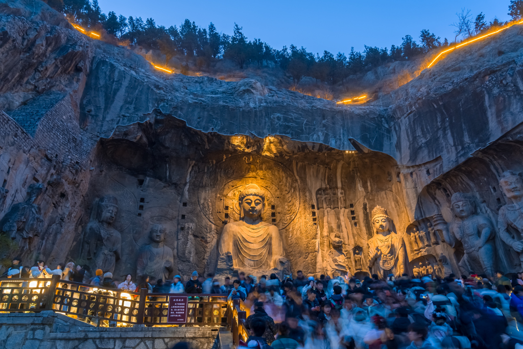 The Lushena Buddha glows amid soft lighting at the Longmen Grottoes in Luoyang, Henan Province on December 31, 2023. /CFP