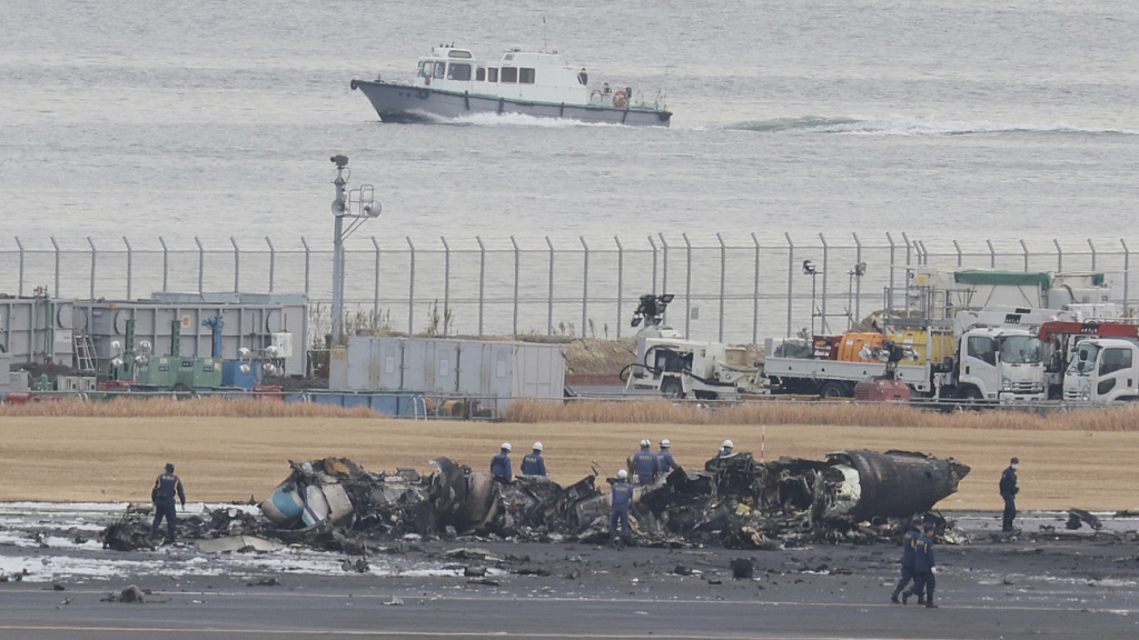 A burnt Japan Airlines plane is pictured on the runway at Haneda Airport in Ota Ward, Tokyo, Japan, January 3, 2024. /CFP