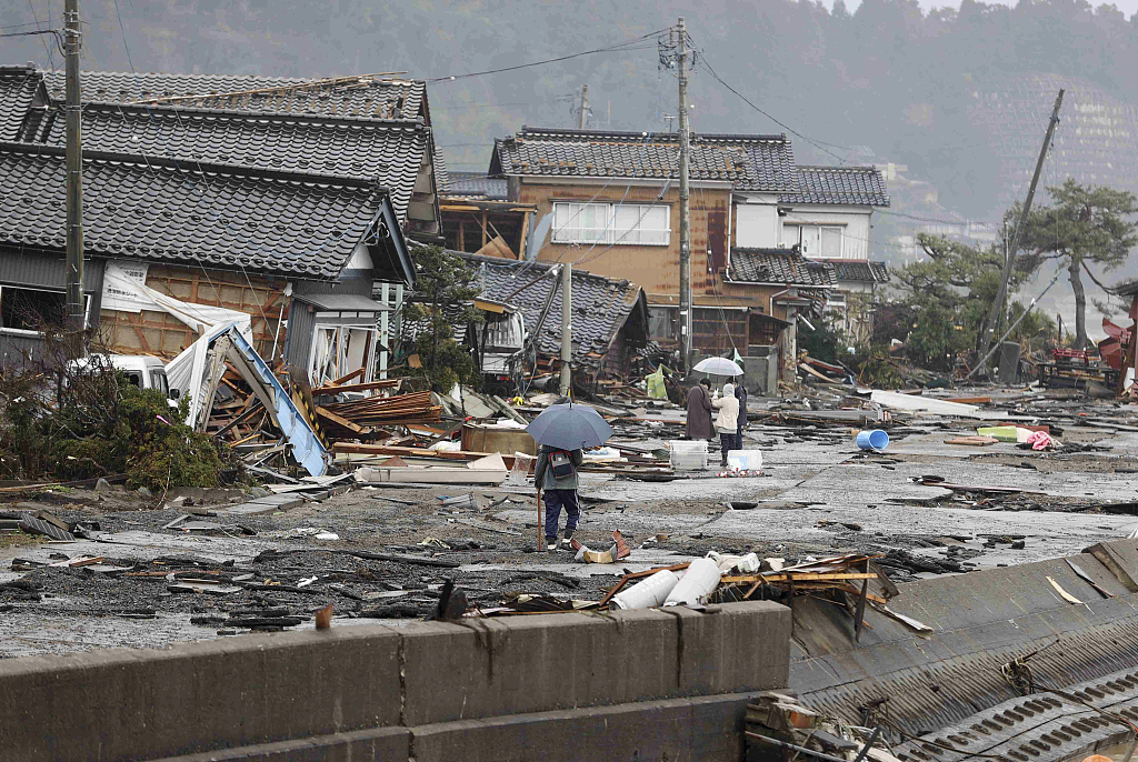 People walk in rain at an area hit by earthquake and tsunami in Suzu City, Ishikawa Prefecture, Japan, January 3, 2024. /CFP 