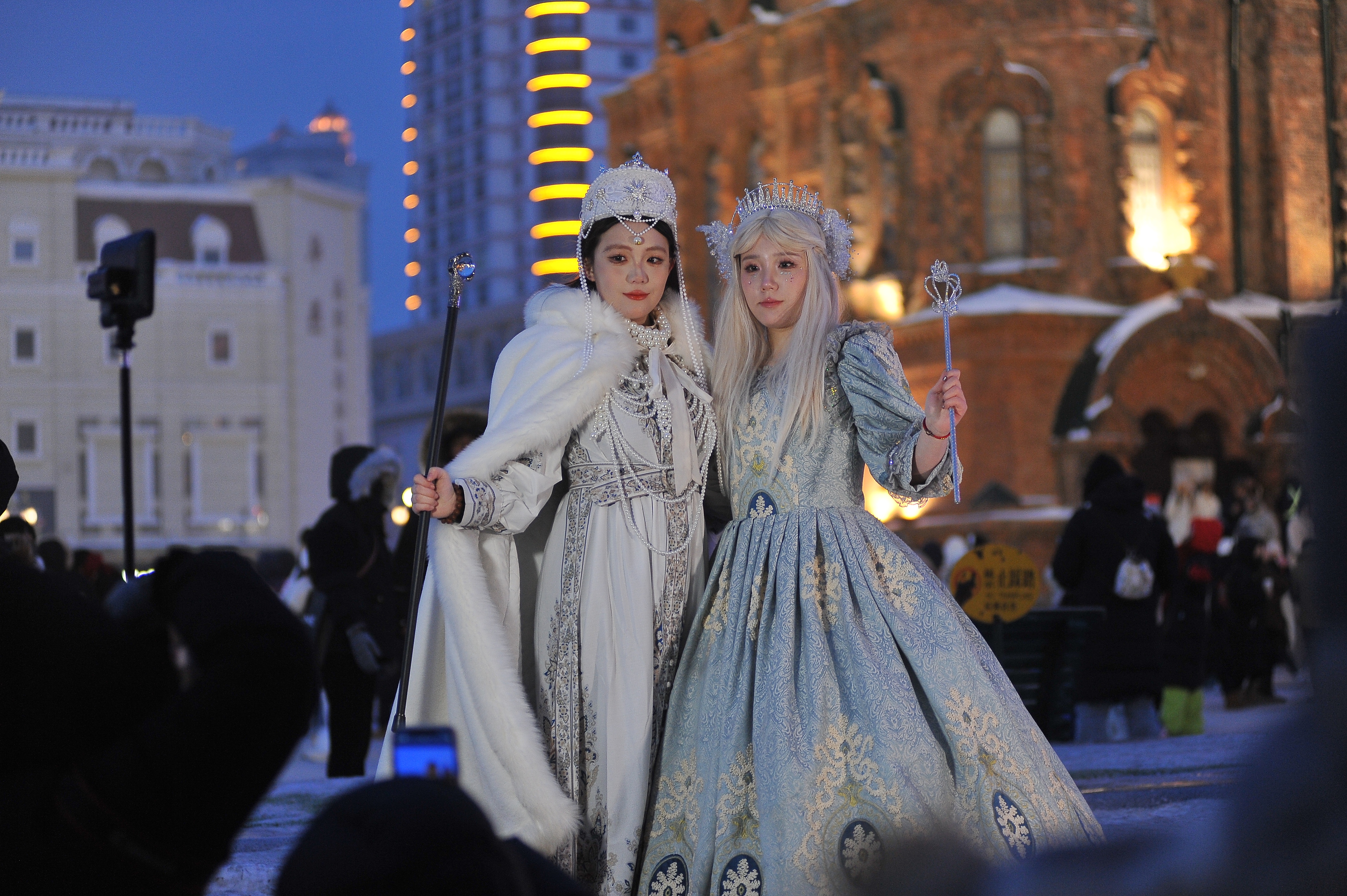 Tourists pose for a photo in costumes against the backdrop of the Saint Sophia Cathedral in Harbin, January 1, 2024. /CFP