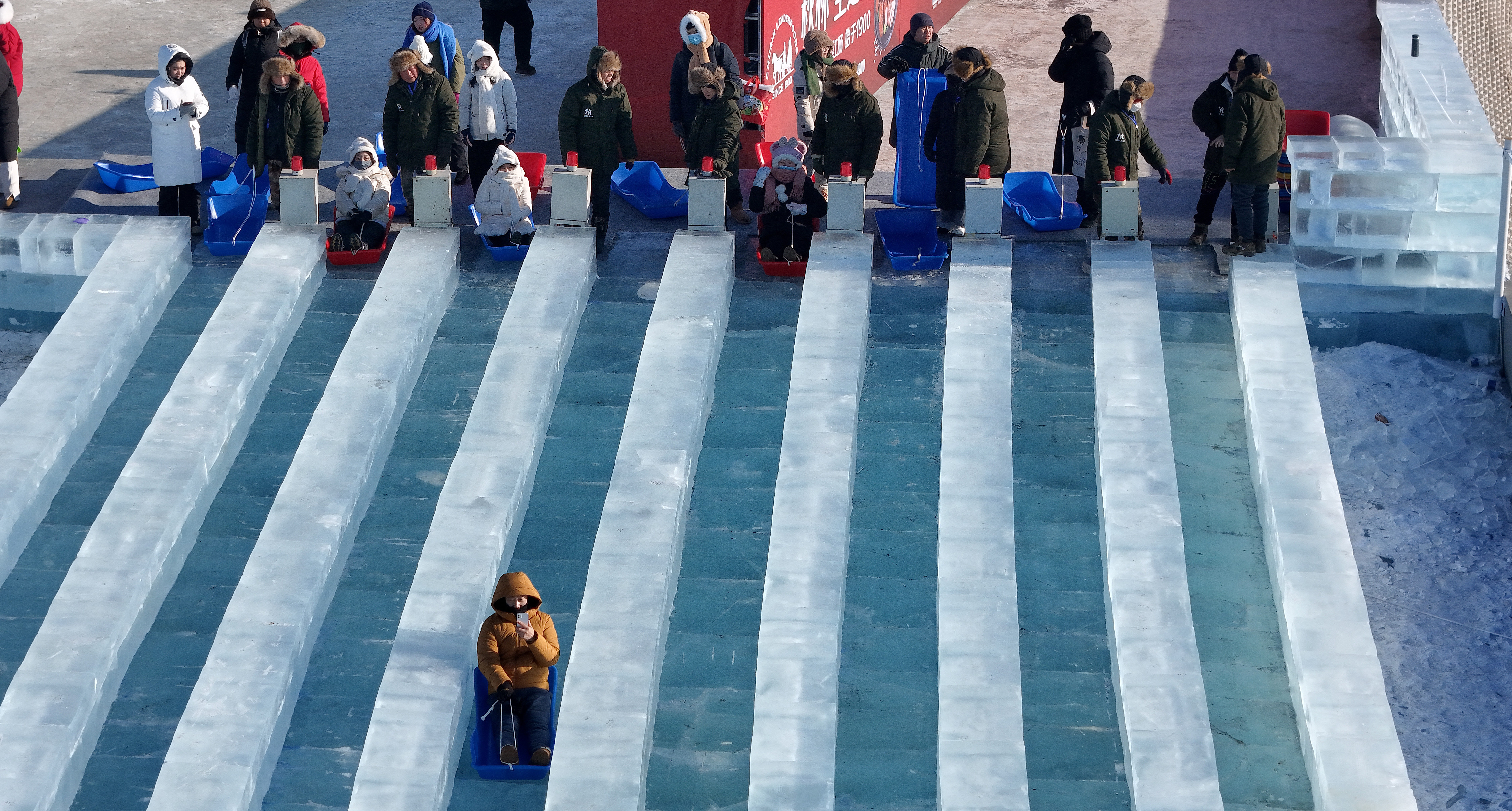 Tourists try the giant ice slide at the Harbin Ice-Snow World in Harbin, December 18, 2023. /CFP