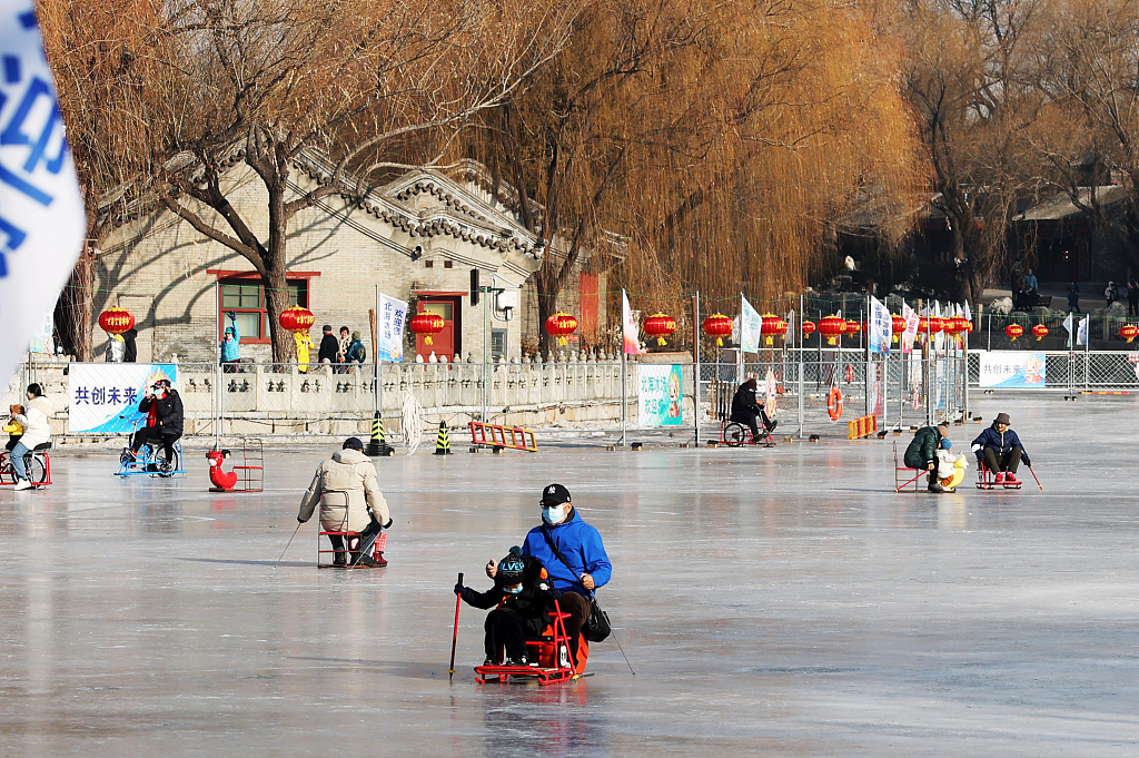 A photo taken on January 4, 2024 shows people enjoying winter activities on the frozen lake in Beihai Park in Beijing, China. /CFP