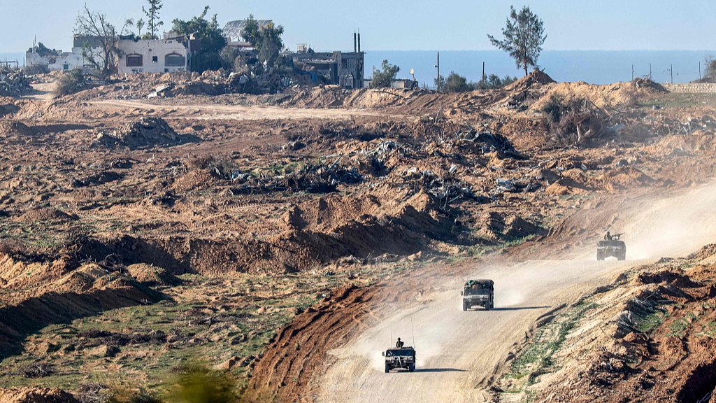 Israeli army humvees move along a dirt road in the Gaza Strip near a position along the border with southern Israel, January 4, 2024. /CFP