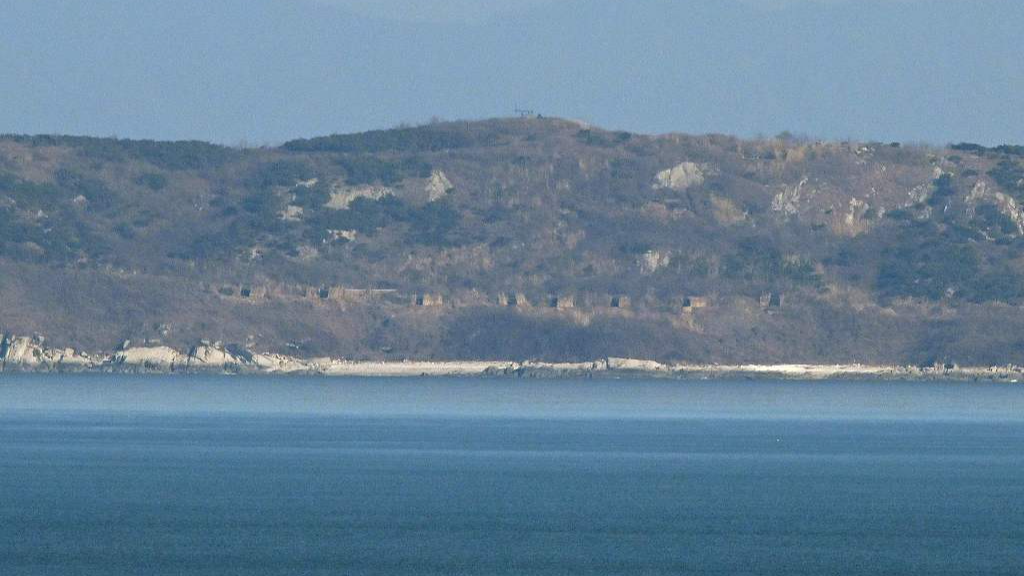 A general view shows the Democratic People's Republic of Korea coastline with artillery bunkers as seen from a viewpoint on Yeonpyeong island, Republic of Korea, January 6, 2024. /CFP