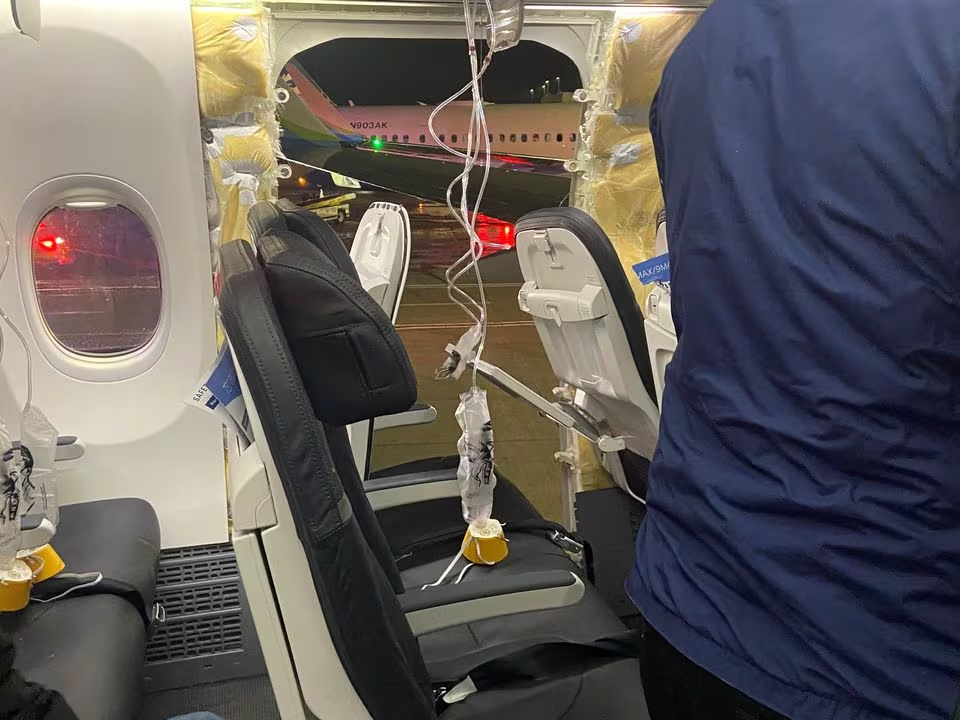 Passenger oxygen masks hang from the roof next to a missing window and a portion of a side wall of Alaska Airlines Flight 1282, which had been bound for Ontario, California, and suffered depressurization soon after departing, Portland, Oregon, U.S., January 5, 2024. /Reuters