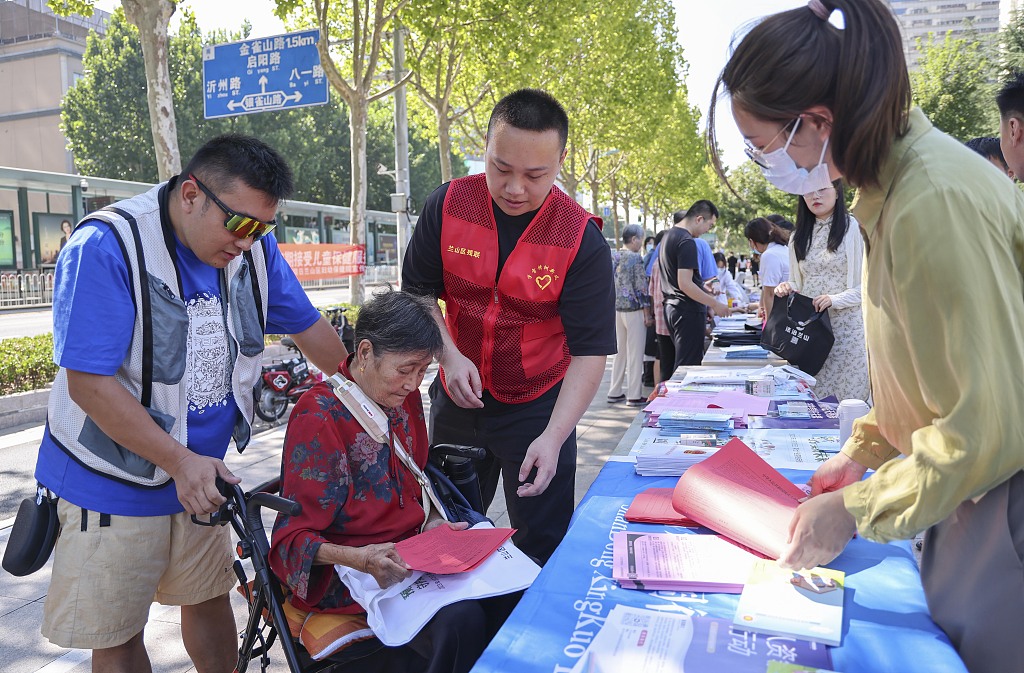 Volunteers explain relevant laws and regulations on the protection of disabled people in Linyi, east China's Shandong Province, August 23, 2023. /CFP