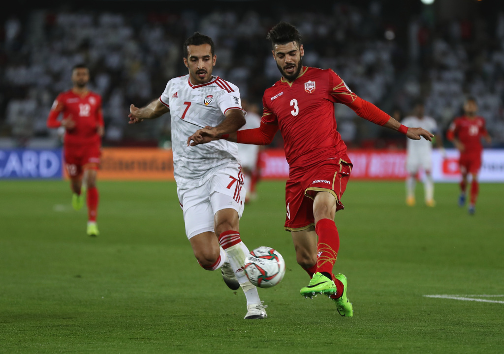 Waleed Al Hayam of Bahrain (R) competes for the ball with Ali Mabkhout of the UAE during an AFC Asian Cup Group A match at Zayed Sports City Stadium on January 5, 2019, in Abu Dhabi, United Arab Emirates. /CFP