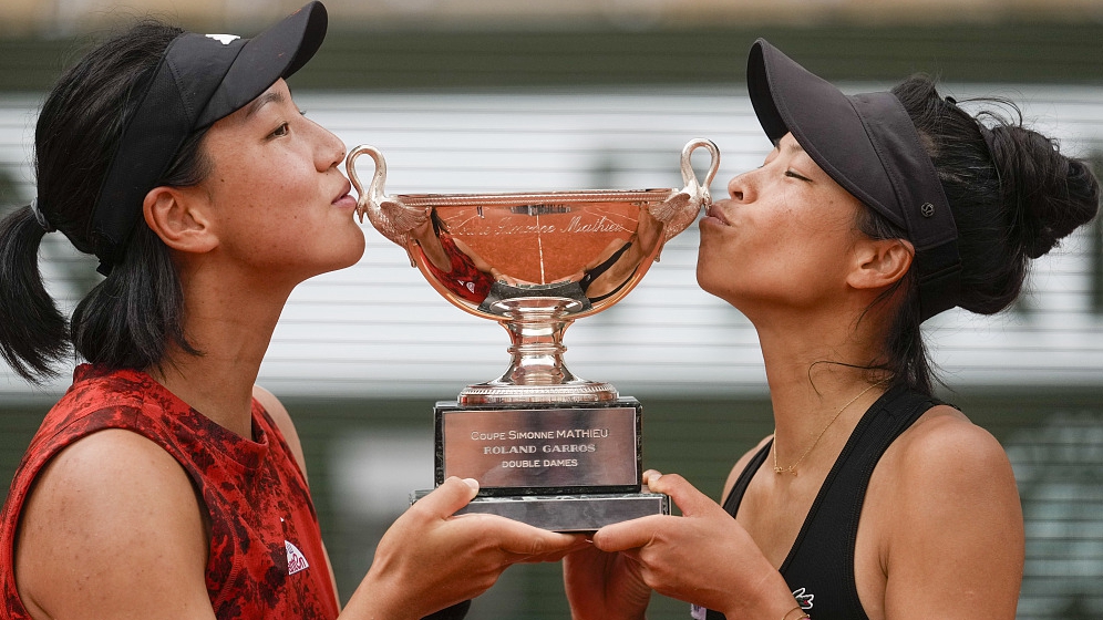 China's Wang Xinyu (L) and Hsieh Su-wei of Chinese Taipei kiss the trophy after winning the women's doubles final match of the French Open in Paris, France, June 11, 2023. /CFP
