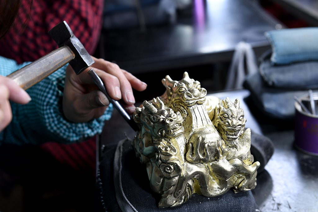A photo taken on December 17, 2023 offers a close-up view of how craftsmen create engraved copper seals in Yuncheng, Shanxi Province, China. /CFP