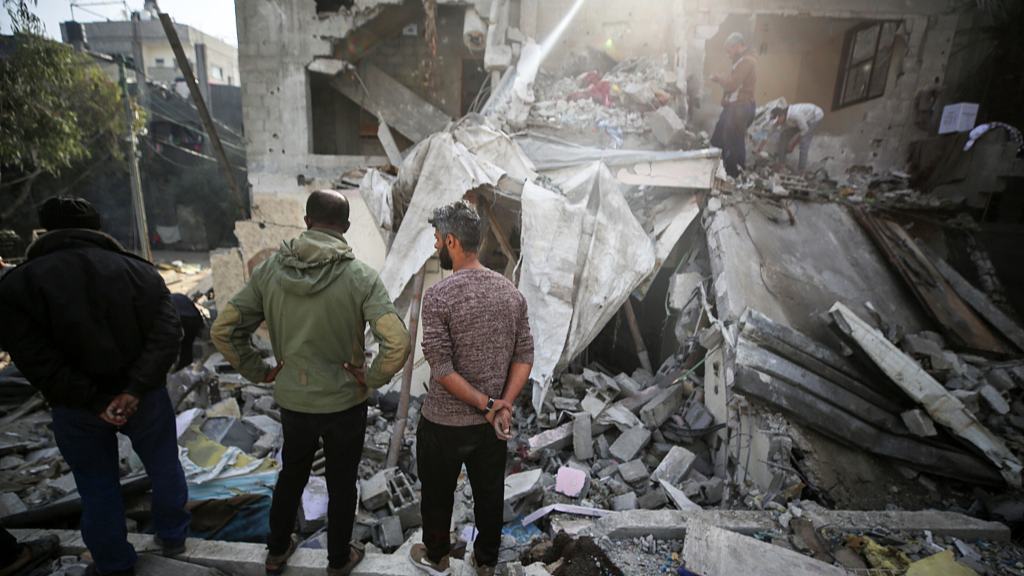People search through the rubble of a house that was destroyed during an Israeli strike in Deir al-Balah, central Gaza Strip, January 8, 2024. /CFP