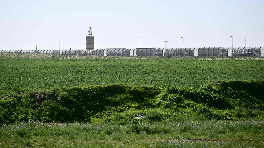 A picture taken from the Israeli side of the Kerem Shalom border crossing with the southern Gaza Strip shows trucks carrying humanitarian aid queuing on the Egyptian side before entry to the Palestinian territory, December 22, 2023. /CFP