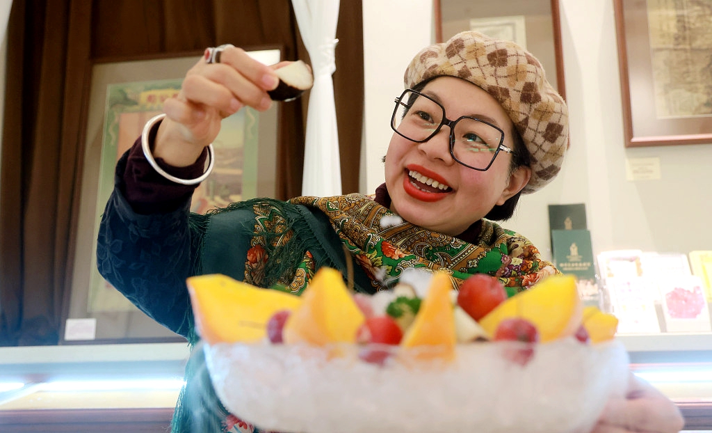 A bowl of frozen fruit attracts the attention of a customer in Harbin on January 9, 2024. /CFP