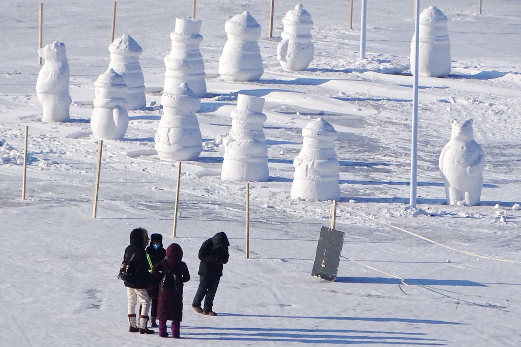Tourists admire the snowmen on show at the Songhua River Ice and Snow Carnival Park in Harbin, Heilongjiang Province, on January 9, 2024. /IC