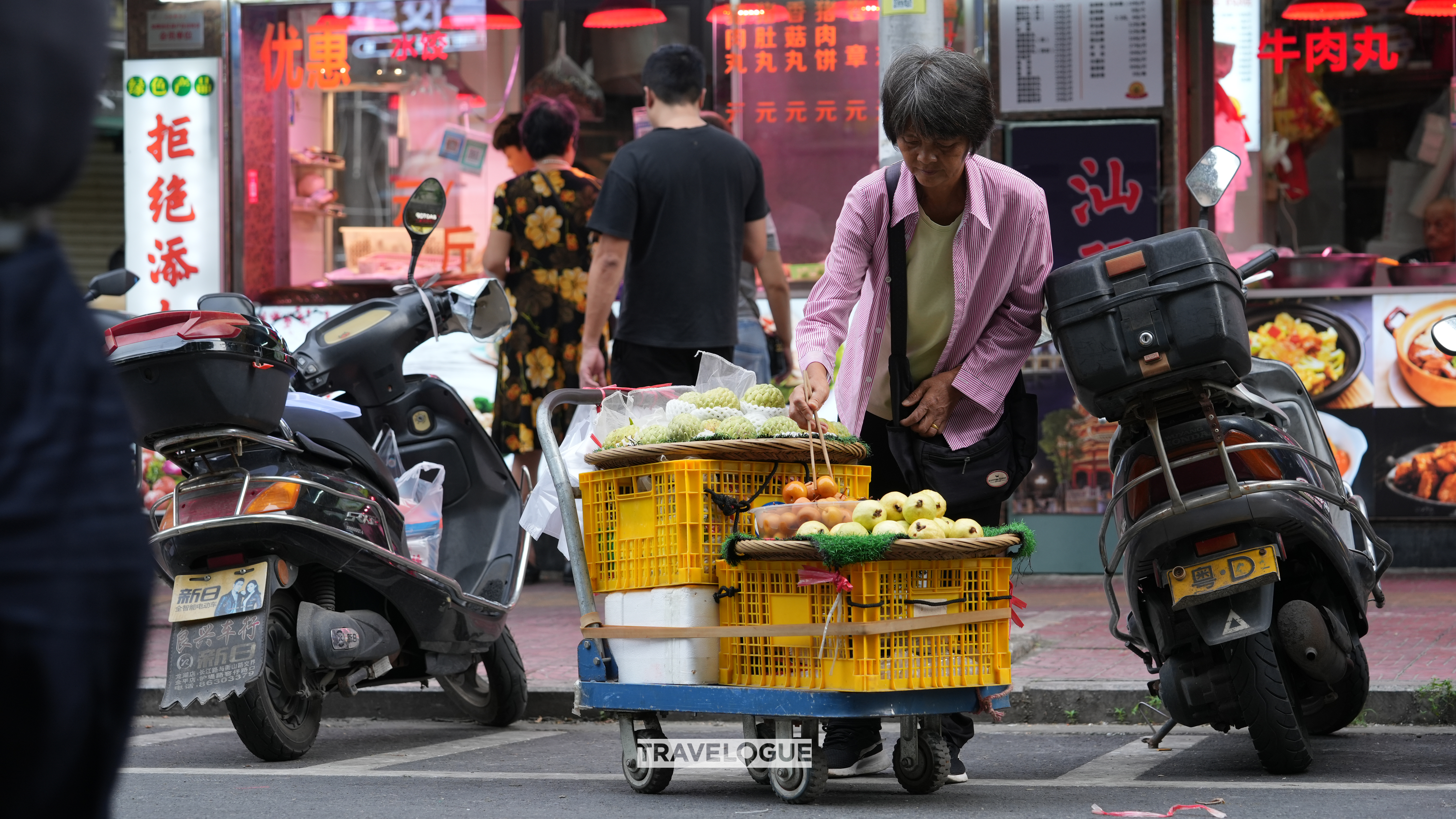A vendor sells vegetables outside a local market in Shantou, Guangdong Province. /CGTN