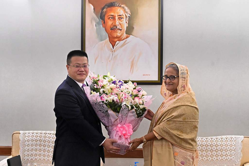 Chinese Ambassador to Bangladesh Yao Wen (L) congratulates Bangladesh's Prime Minister Sheikh Hasina with a floral bouquet in Dhaka on January 8, 2024. /CFP