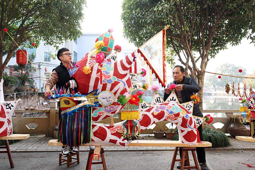 Photo taken on January 10, 2024 shows craftsmen in Dongyang, Zhejiang Province, working on dragon heads, adding a touch of tradition and festivity to the atmosphere as Spring Festival approaches. /CFP