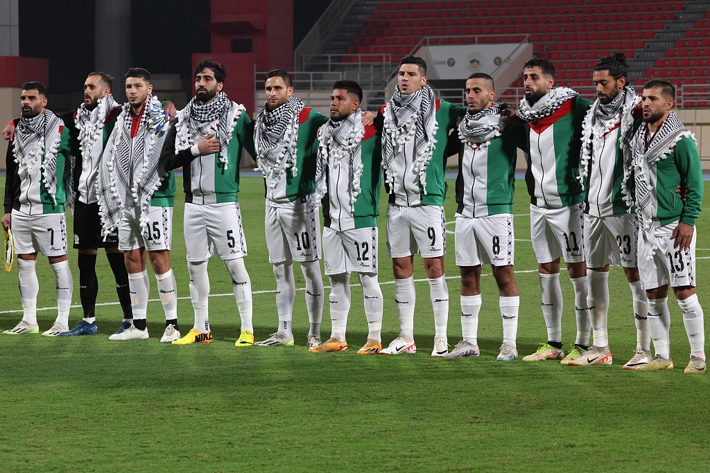 Palestine's starting eleven gather for their national anthem ahead of the 2026 FIFA World Cup AFC qualifying match against Lebanon at the Khalid Bin Mohammed Stadium in Sharjah, the UAE, on November 16, 2023. /CFP