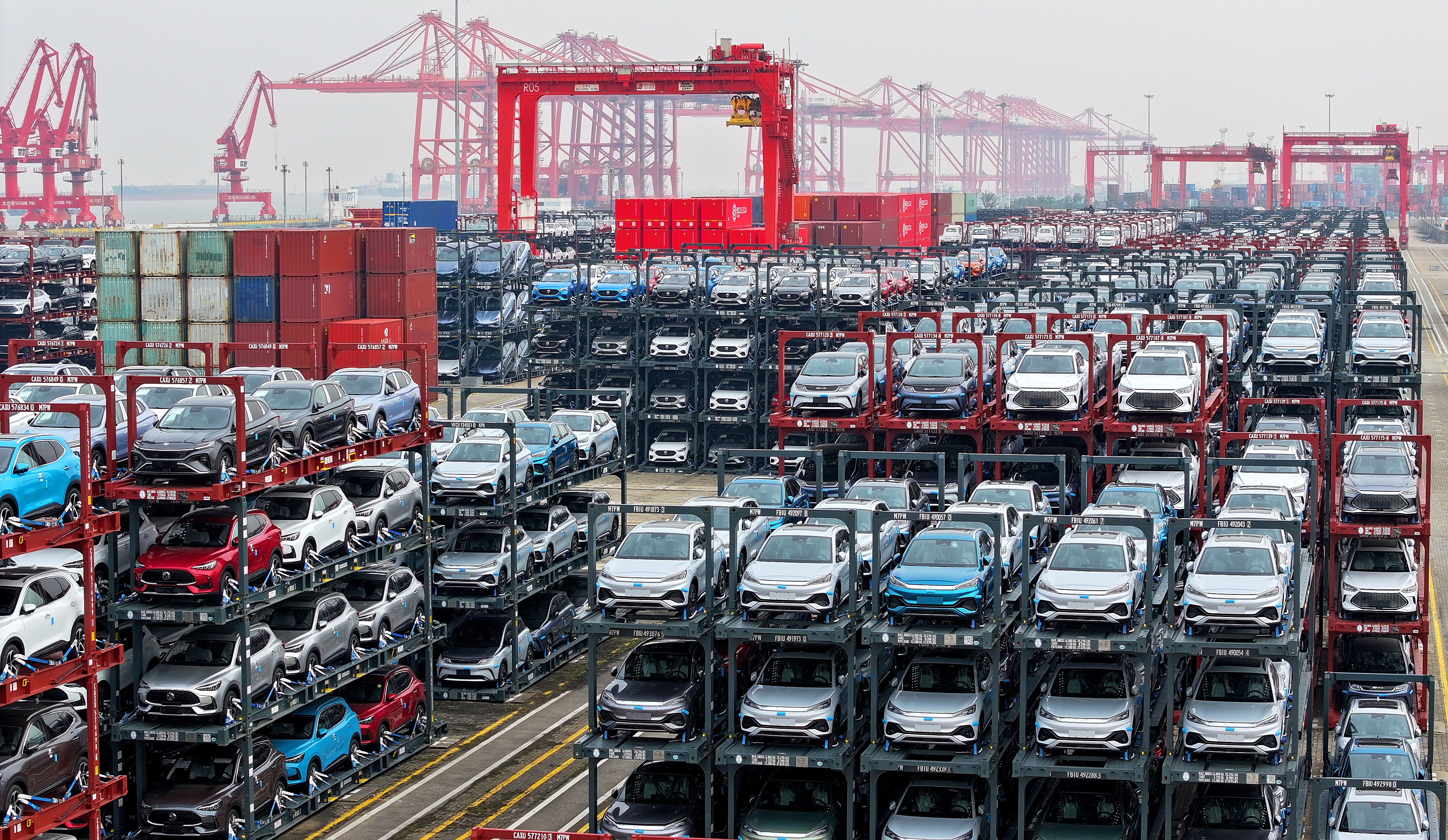 A batch of new energy vehicles wait to be exported at an international container terminal of Taicang Port, east China's Jiangsu Province, December 13, 2023. /CFP