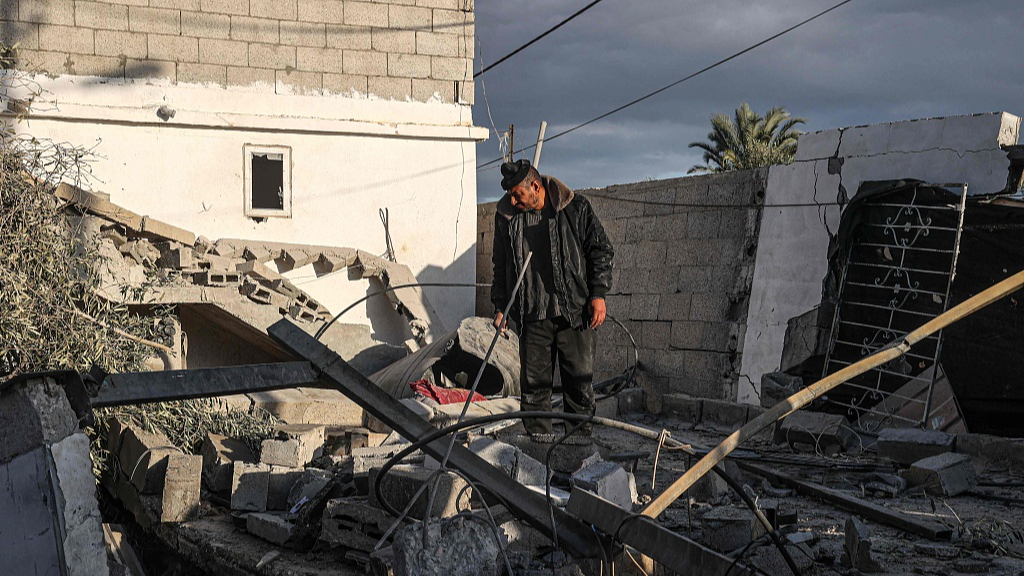 A Palestinian man checks the damages to a house following Israeli bombardment in Rafah in the southern Gaza Strip, January 12, 2024. /CFP