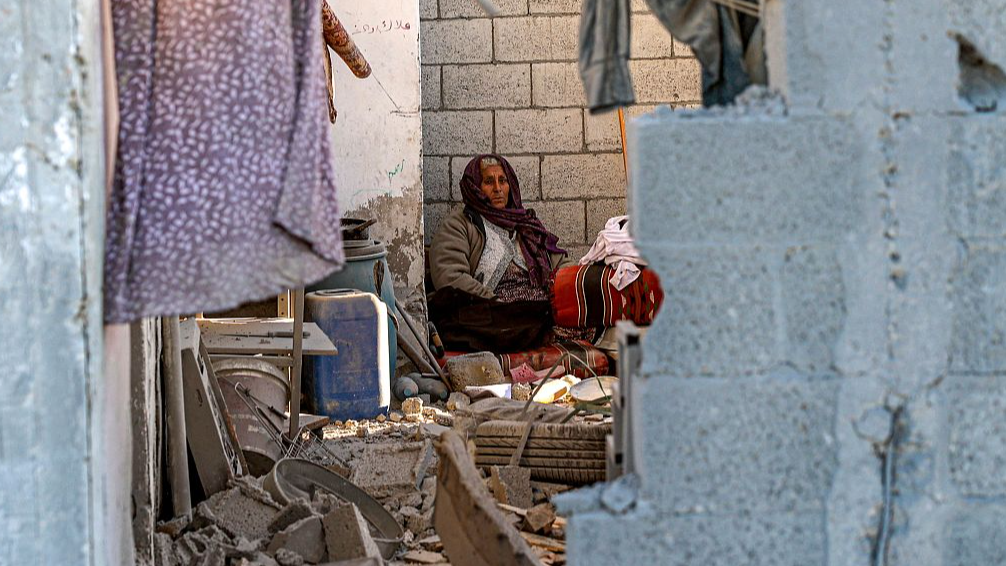 A woman sits in a damaged house following Israeli bombardment in Rafah in southern Gaza, January 13, 2024. /CFP