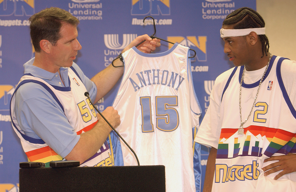 Carmelo Anthony (R) of the Denver Nuggets is given the No. 15 jersey at the press conference at the Pepsi Center in Denver, Colorado, June 27, 2003. /CFP