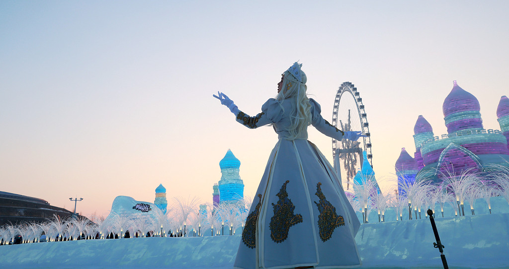 A visitor poses for a photo at the Harbin Ice and Snow World in Harbin, northeast China's Heilongjiang Province, December 23, 2023. /CFP