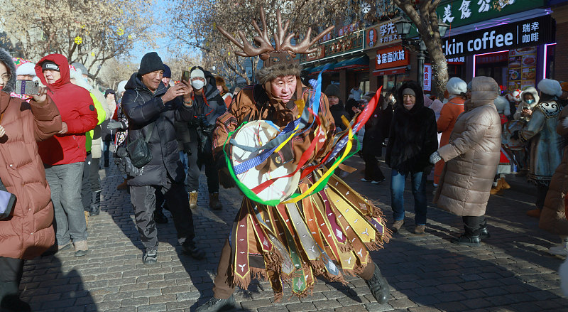 Hezhe people perform traditional dances and sing songs to demonstrate their unique culture to visitors in Harbin City, Heilongjiang Province, January 15, 2024. /CFP