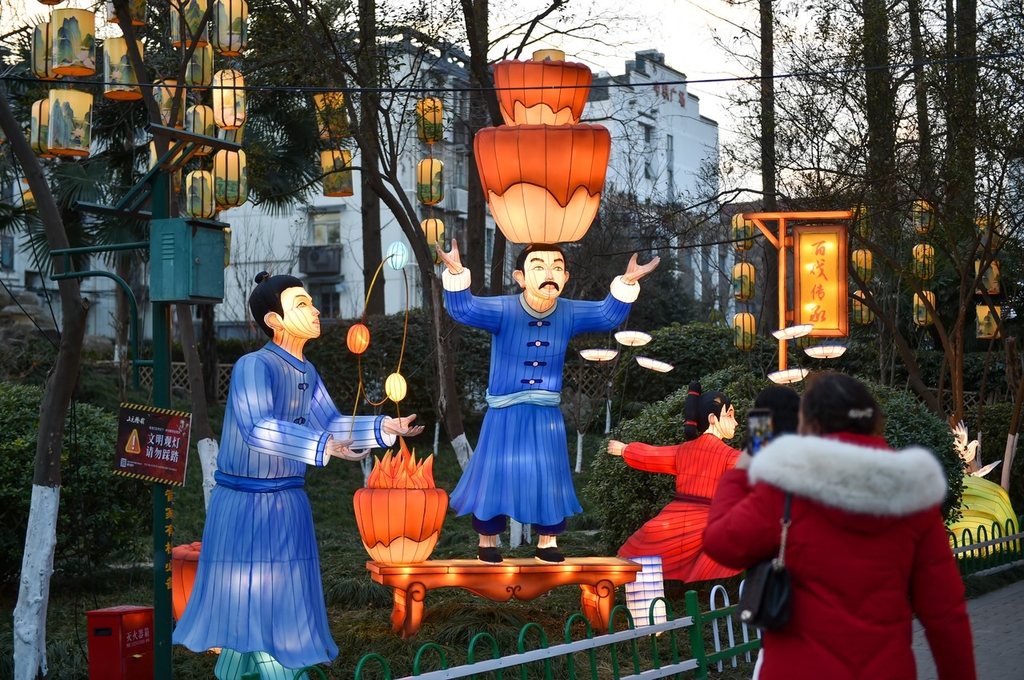 A photo taken on January 15, 2024 at Bailuzhou Park in Nanjing, Jiangsu shows a set of lanterns depicting scenes of people performing juggling and balancing acts. /IC