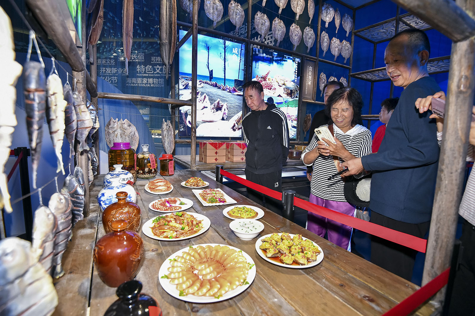 Visitors learn about Danjia cuisine at a museum showcasing Danjia culture in Lingshui, Hainan Province on December 28, 2023. /IC