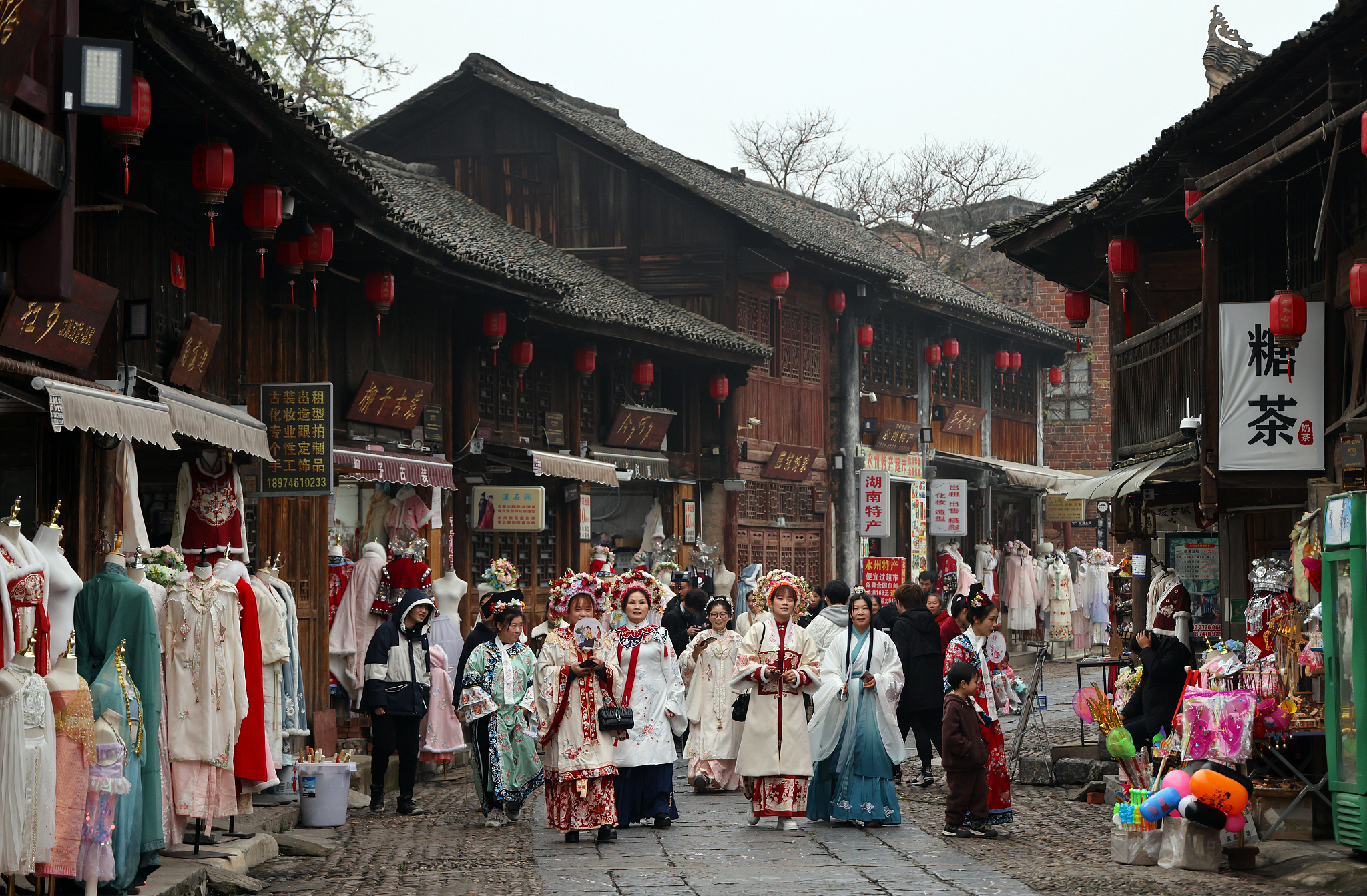 Tourists donning ancient costumes enjoy a time-travel experience on an ancient Street, Yongzhou City, central China's Hunan Province, January 16, 2023. /CFP