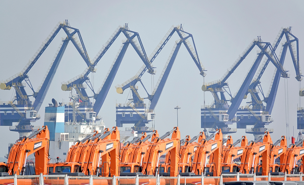 A crane operates at Yantai Port in Shandong Province on January 17, 2023, loading and unloading goods onto a cargo ship./CFP