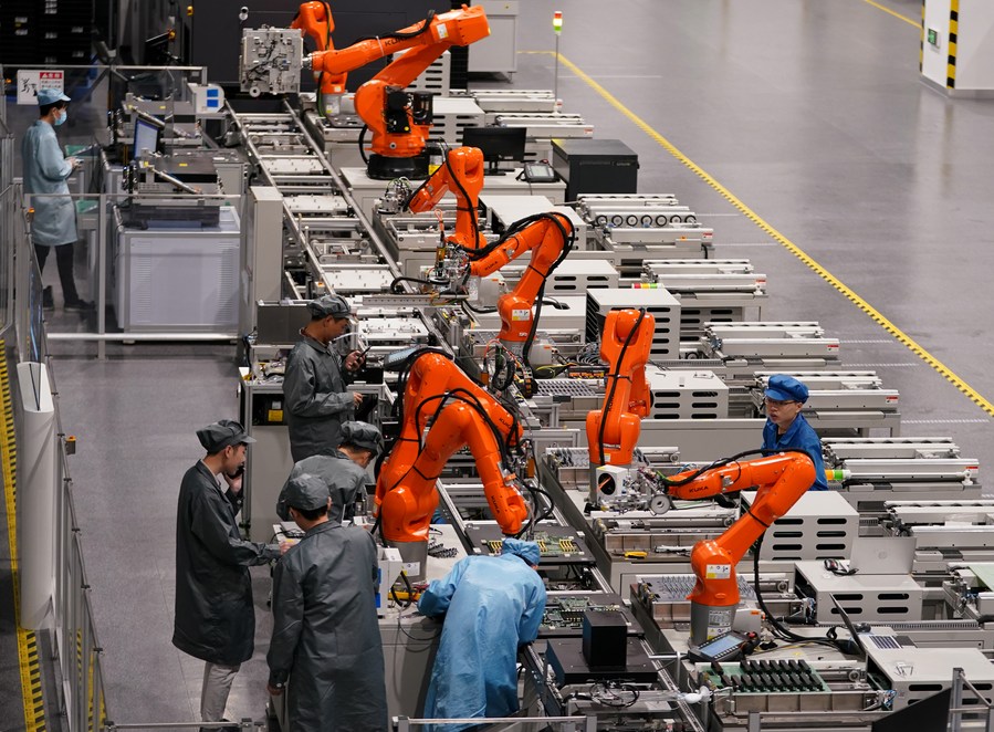 Technical staff members work on a production line at a future factory of Unisplendour Corporation Limited (UNIS) in Xiaoshan District of Hangzhou, east China's Zhejiang Province, April 27, 2023. /Xinhua