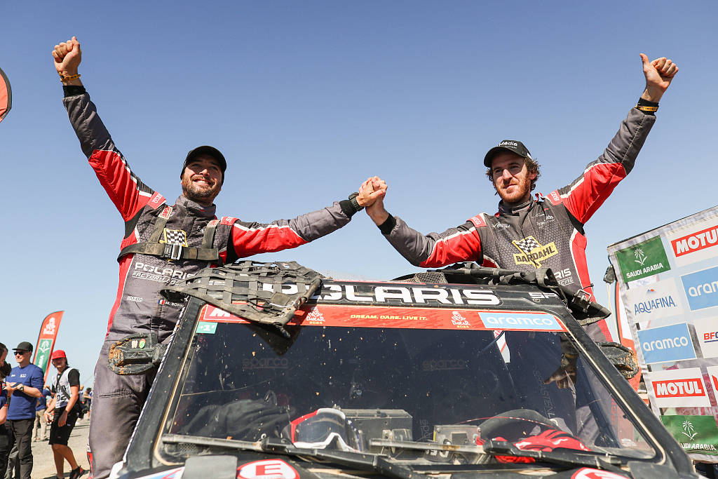 France's Xavier De Soultrait (R) and co-driver Martin Bonnet of Team Sebastien Loeb Racing celebrate their victory in the SSV category during the Dakar Rally in Yanbu, Saudi Arabia, January 19, 2024. /CFP