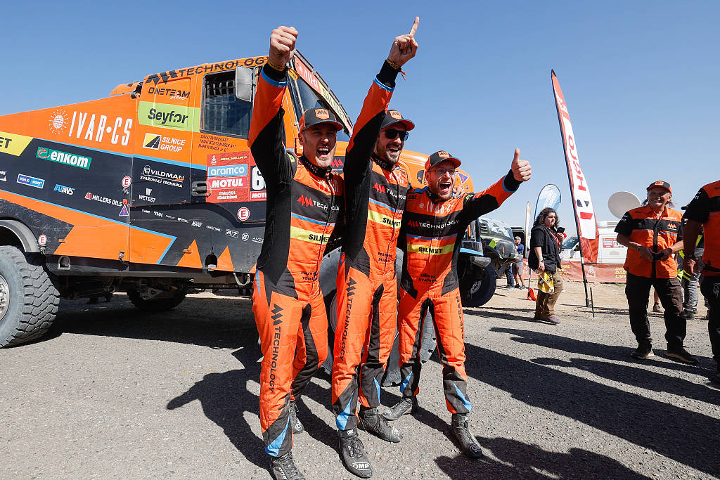 Czech Republic's Martin Macik (C), co-driver Frantisek Tomasek (L) and mechanic David Svanda of MM Technology Team celebrate after winning the truck title during the Dakar Rally in Yanbu, Saudi Arabia, 2024. /CFP