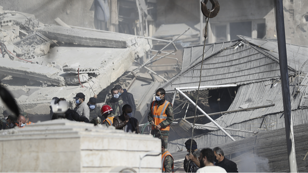 Emergency services work at a building hit by an air strike in Damascus, Syria, January 20, 2024. Syrian and Iranian state media outlets say an Israeli strike on Damascus killed four Iranian advisers. /CFP