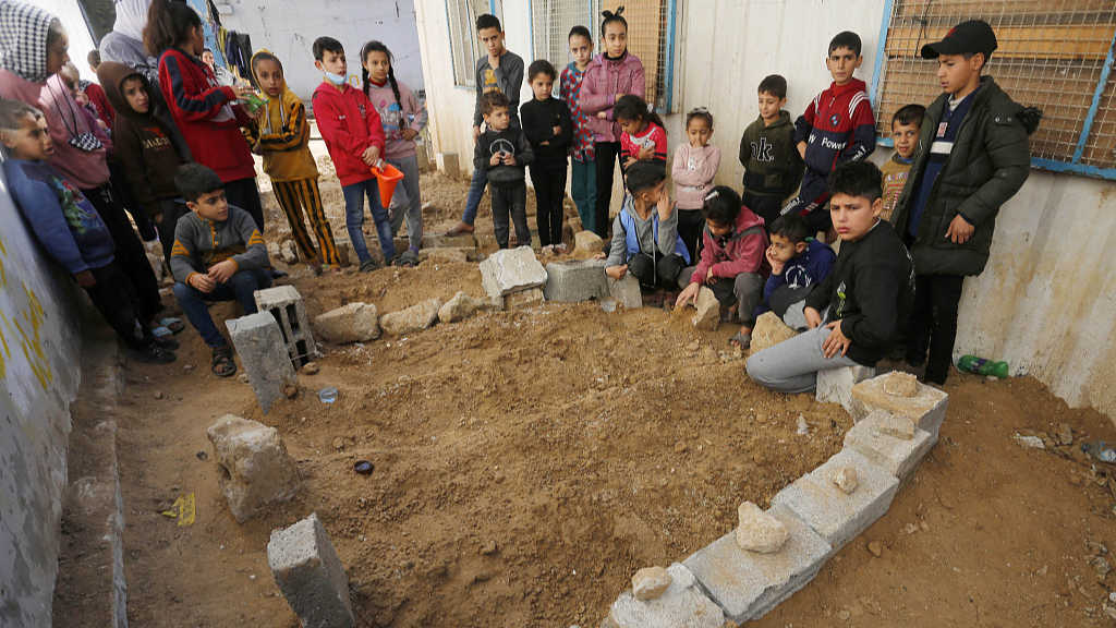 Bodies of some Palestinians killed in the Israeli attacks are buried in the garden of a school affiliated to the United Nations Relief and Works Agency for Palestine Refugees (UNRWA) at the Bureij refugee camp after Israeli forces withdrew from the area in Deir Al Balah, Gaza on January 18, 2024. /CFP