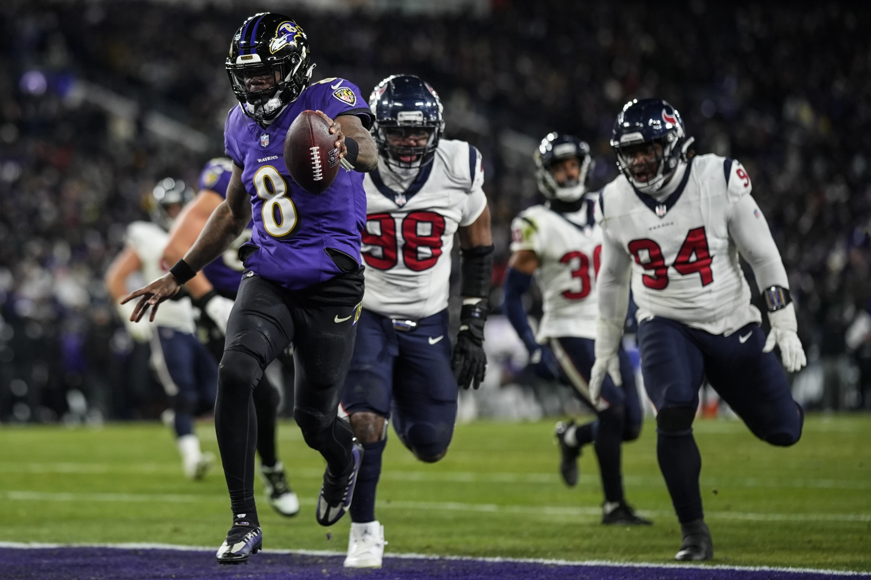 Quarterback Lamar Jackson (#8) of the Baltimore Ravens scores a touchdown in the National Football League American Football Conference Divisional Game against the Houston Texans at M&T Bank Stadium in Baltimore, Maryland, January 20, 2024. /AP