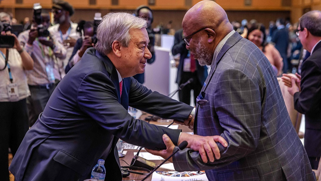 UN Secretary-General Antonio Guterres (L) greets President of the UN General Assembly Dennis Francis (R) during the opening session of the Third South Summit of the Group of 77 and China in Kampala, January 21, 2024. /CFP