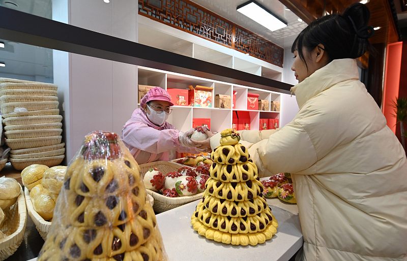A shopper buys huabobo for the upcoming Chinese New Year in Gaomi, Shandong Province, January 20, 2024. /CFP
