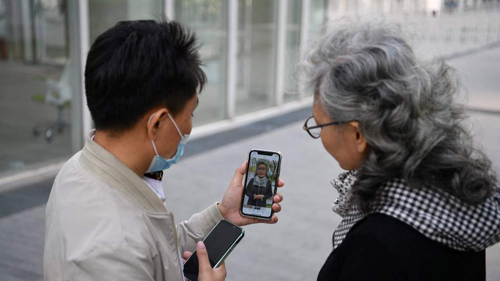 This photo taken on April 9, 2021 shows social media influencer and granny Ruan Yaqing (R) with assistant Xie Xincun (L) as they check a short video for her channel on video-sharing apps Kuaishou and Douyin - China's version of TikTok - in Beijing, China./CFP
