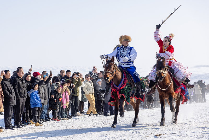 Visitors enjoy a horse race during a tourist festival in Tacheng Prefecture, Xinjiang, January 21, 2024. /CFP