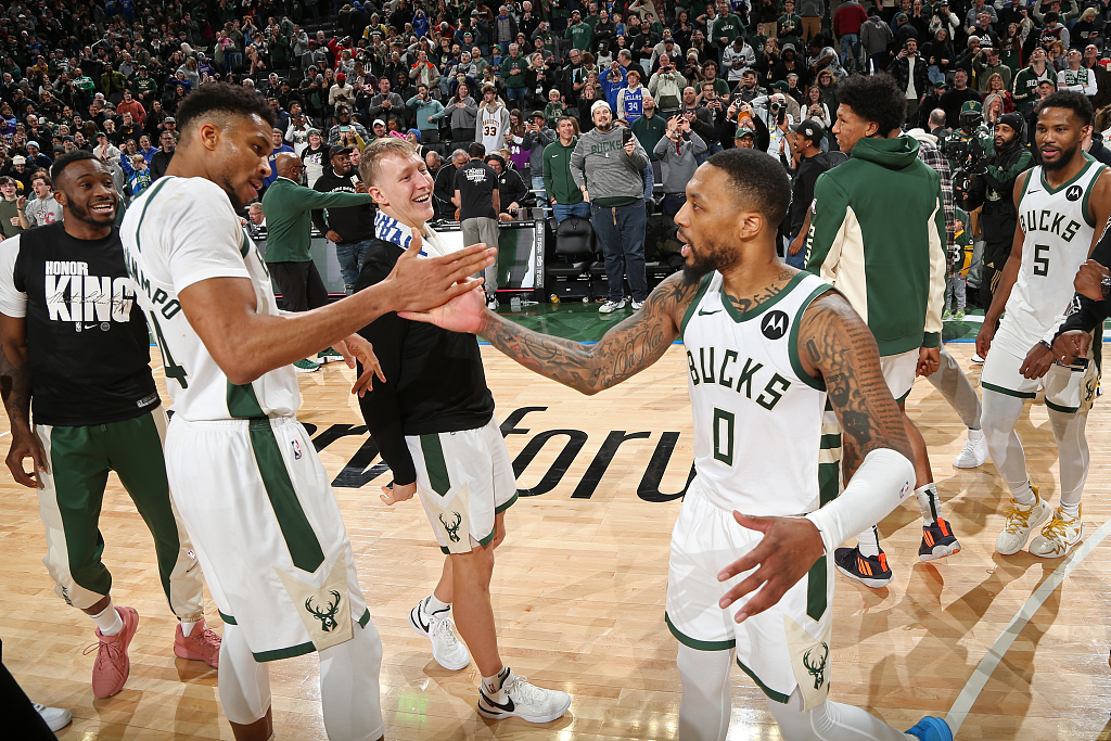 Giannis Antetokounmpo (L) and Damian Lillard of the Milwaukee Bucks celebrate after the 143-142 win over the Sacramento Kings at Fiserv Forum in Milwaukee, Wisconsin, U.S., January 14, 2024. /CFP