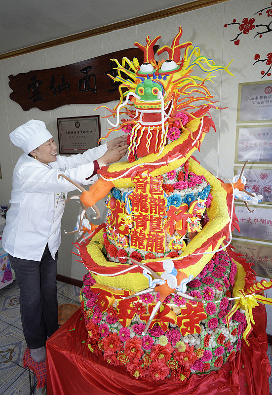 Dough sculpture inheritor Xie Yunxian creates a loong-shaped dough sculpture to herald the upcoming Chinese New Year in Yuncheng, Shanxi Province, January 23, 2024. /CFP