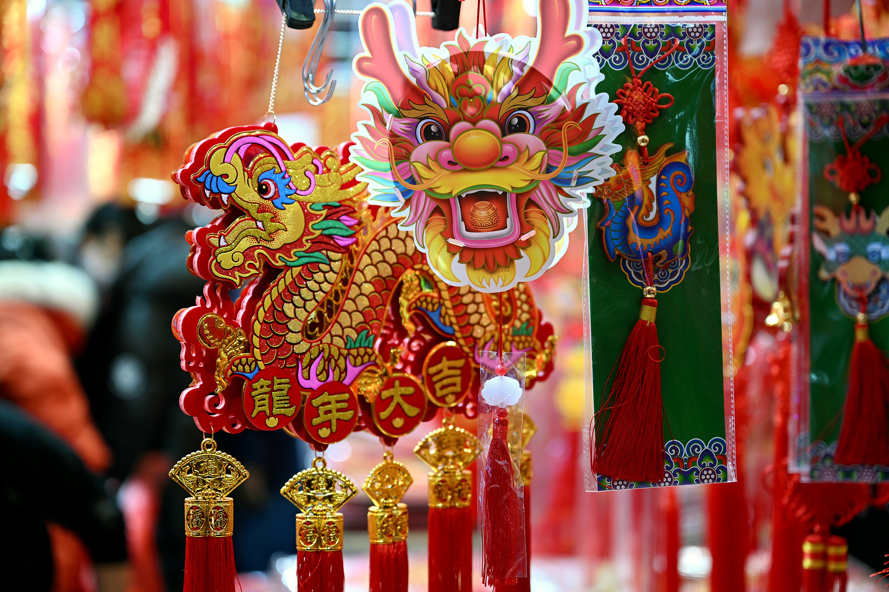 New Year ornaments featuring the Chinese dragon are seen at a small commodity market in Shenyang City, northeast China's Liaoning Province, December 24, 2023. /CFP