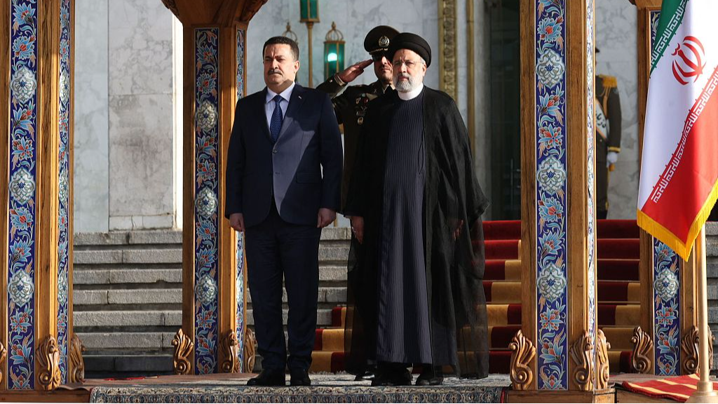 A handout picture provided by the Iranian Presidential Office on November 6, 2023, shows Iranian President Ebrahim Raisi (R) welcoming Iraq's Prime Minister Mohammed Shia' al-Sudani in Tehran. /CFP