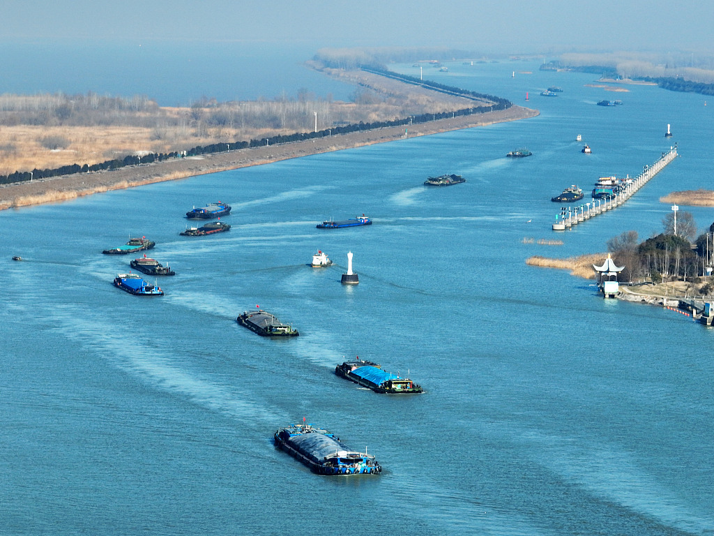 Cargo boats sail through the Yangzhou section of the Grand Canal, creating a busy scene, January 24, 2024. /CFP