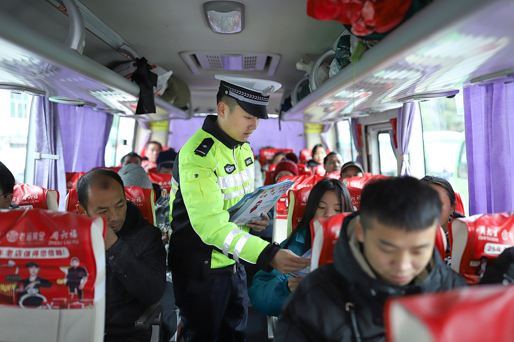 The police educate passengers about road traffic safety on a bus, Qiandongnan Miao and Dong Autonomous Prefecture, southwest China's Guizhou Province, January 26, 2024. /CFP