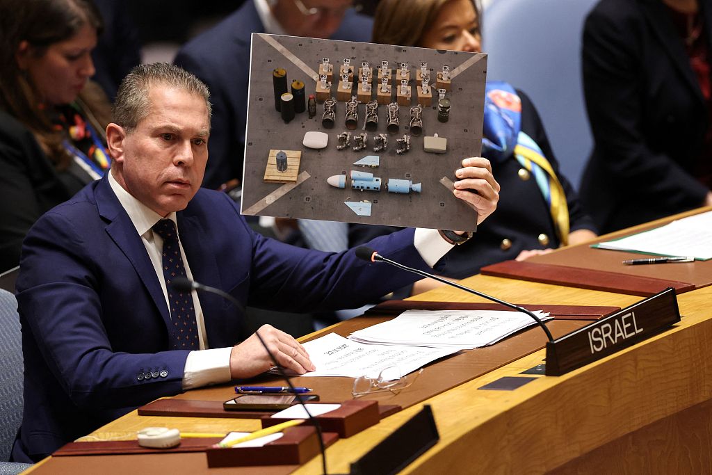 Israel's Ambassador to the United Nations Gilad Erdan shows a picture of weapons alledgedly found in Gaza by Israeli troops as he speaks during a United Nations Security Council meeting to discuss the situation in the Middle East at UN headquarters in New York, January 23, 2024. /CFP
