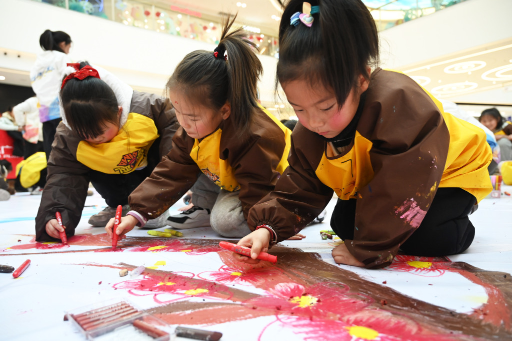 Children work together to color in a Chinese dragon-themed painting in Xuzhou, Jiangsu Province, January 27, 2024. /CFP
