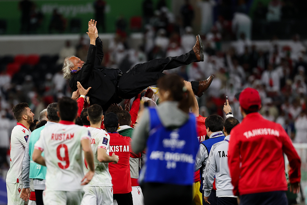 Tajikistan coach Petar Segrt is thrown into the air by his players after their Asian Cup clash with United Arab Emirates at Ahmad Bin Ali Stadium in Al-Rayyan, Qatar, January 28, 2024. /CFP